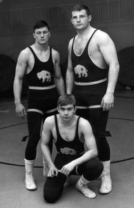 Photo Courtesy of NDSU Athletics - Three Bison wrestlers pose for the 1960 wrestling poster. The 1960 team went 8-6 under the program's first coach, Tom Neuberger. 