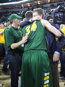 Photo by Gabrielle K. Hartz - First year head coach Dave Richman hugs Bison big man Chris Kading among a crowd of fans after the final horn in the Summit League championship game.