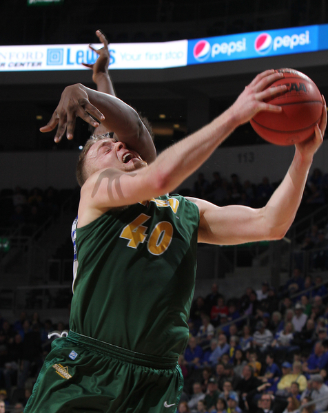 North Dakota State Bison men's basketball player Dexter Werner absorbs contact in the 2016 Summit League men's basketball tournament
