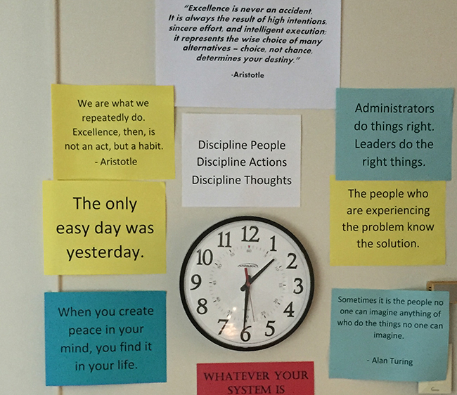 Mike Favor's clock in his office. Aristotle quotes.