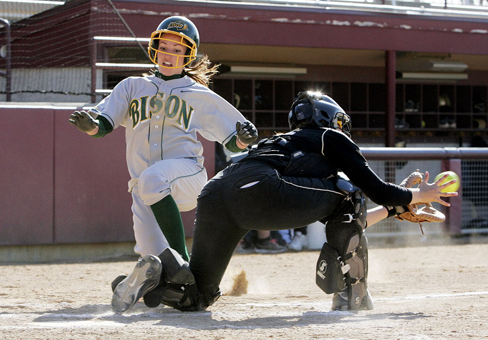 Taylor (Lynn) Ungricht slide into home plate while playing softball for the NDSU Bison.