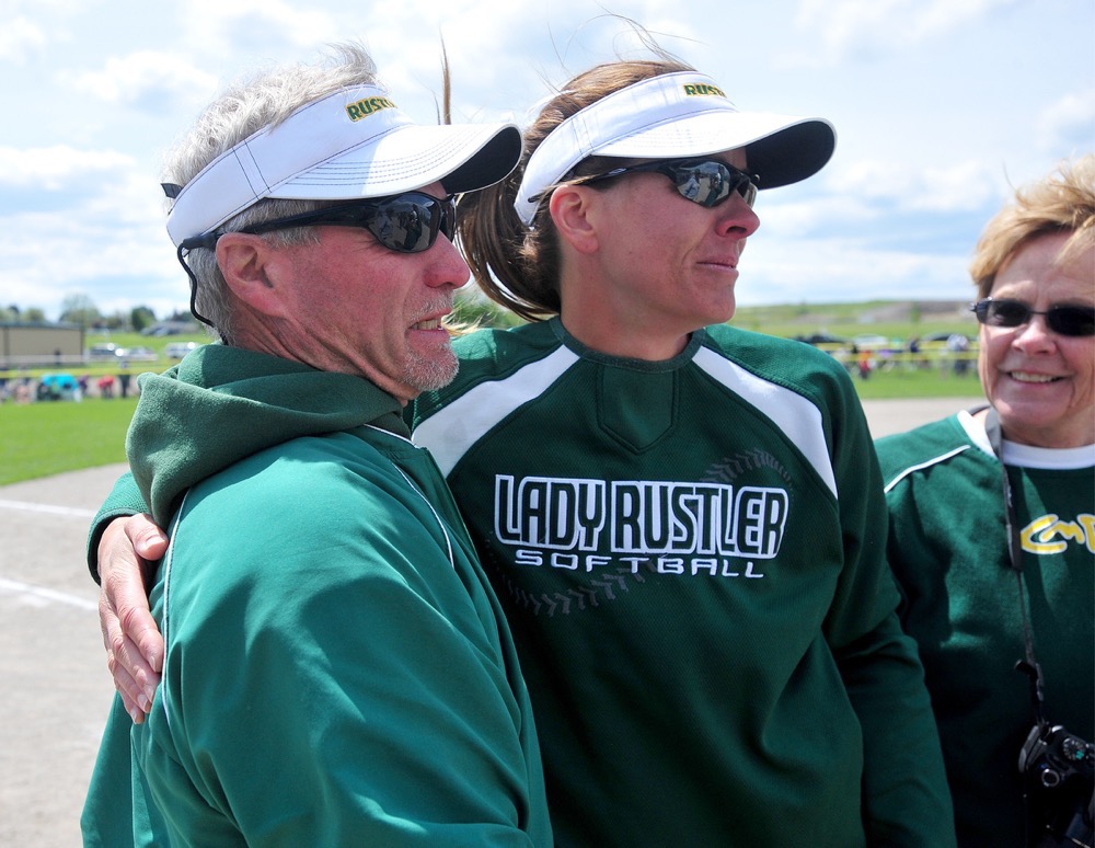 CMR coach Lindsey Gustafson hugs her father, Terry Graham, after her Rustlers team defeated Glacier 3-1 in the Class AA state title game at the Class AA softball tournament in Kalispell on Saturday.